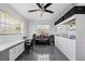 Spacious office with gray tile floor, a ceiling fan, lots of storage, and plenty of natural light at 7892 10Th S Ave, St Petersburg, FL 33707