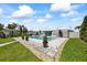 Outdoor pool and patio area offering ample space for relaxation and entertainment, complemented by lush landscaping at 7892 10Th S Ave, St Petersburg, FL 33707