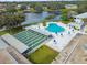 Aerial shot of a community recreation center with a shuffleboard court and unique kidney-shaped pool at 8080 112Th St # 108, Seminole, FL 33772