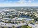 Wide aerial shot showing the condos and surrounding neighborhood with lush landscaping and water views at 8080 112Th St # 108, Seminole, FL 33772