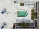 Aerial view of the community spa with blue umbrellas and chairs in a courtyard with some landscaping at 8080 112Th St # 108, Seminole, FL 33772