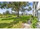 Manicured lawn outside of the condominium with mature trees and lush landscaping at 8080 112Th St # 108, Seminole, FL 33772