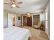 Bedroom featuring ceiling fan, wood floors, a closet, and lots of natural light at 8080 112Th St # 108, Seminole, FL 33772