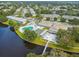 Aerial view of the community pool with a scenic water view and lush landscaping in a park-like setting at 8080 112Th St # 108, Seminole, FL 33772