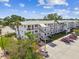 Aerial view of the condo building and parking lot featuring mature landscaping and multiple levels at 8080 112Th St # 108, Seminole, FL 33772