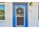 Blue front door features a storm door with a wreath and house number at 8080 112Th St # 108, Seminole, FL 33772
