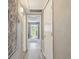Hallway leading to the outdoors with lots of natural light and neutral paint at 8080 112Th St # 108, Seminole, FL 33772