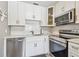 The kitchen features stainless steel appliances, white cabinets, and lots of natural light at 8080 112Th St # 108, Seminole, FL 33772