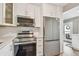 This kitchen features stainless steel appliances and modern white cabinets at 8080 112Th St # 108, Seminole, FL 33772