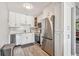 The kitchen features modern stainless steel appliances, white cabinets, and wood look floors at 8080 112Th St # 108, Seminole, FL 33772
