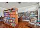 Community library featuring floor to ceiling bookshelves stocked with books, games, and a comfortable chair at 8080 112Th St # 108, Seminole, FL 33772