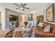Living room featuring a leather sofa, media center and ceiling fan at 8080 112Th St # 108, Seminole, FL 33772