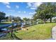 Scenic water view of a canal with a grassy shoreline and lamppost, lush trees, and community homes at 8080 112Th St # 108, Seminole, FL 33772