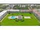 Bright aerial view of condos surrounding meticulously maintained lawns, pool and shuffleboard courts at 8100 Dr Martin Luther King Jr N St # 202, St Petersburg, FL 33702