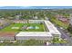 Bright aerial view of multi-unit residential community with pool, shuffleboard and mature trees at 8100 Dr Martin Luther King Jr N St # 202, St Petersburg, FL 33702