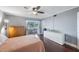 Bright bedroom with hardwood floors, ceiling fan, and a large white dresser at 8100 Dr Martin Luther King Jr N St # 202, St Petersburg, FL 33702