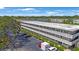 Exterior view of the condo building showcasing well-maintained landscaping and ample parking at 8100 Dr Martin Luther King Jr N St # 202, St Petersburg, FL 33702