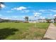 Exterior view from lawn of multi-unit residential building with large green lawn and mature palms at 8100 Dr Martin Luther King Jr N St # 202, St Petersburg, FL 33702