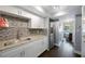 Bright kitchen with granite counters, mosaic backsplash, and stainless steel refrigerator at 8100 Dr Martin Luther King Jr N St # 202, St Petersburg, FL 33702