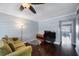 Bright living room with hardwood floors, a ceiling fan, and modern entertainment setup at 8100 Dr Martin Luther King Jr N St # 202, St Petersburg, FL 33702