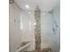 Stylish walk-in shower featuring modern fixtures, glass enclosure, and mosaic tile accents at 8100 Dr Martin Luther King Jr N St # 202, St Petersburg, FL 33702