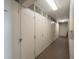 Long storage units with white doors and metal vents in a shared hallway at 8100 Dr Martin Luther King Jr N St # 202, St Petersburg, FL 33702