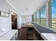 Bright sunroom featuring large windows with shutters and access to the bedroom at 8100 Dr Martin Luther King Jr N St # 202, St Petersburg, FL 33702