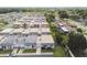 An aerial view shows well-maintained homes in a verdant neighborhood with mature trees at 8447 Orleans N, Pinellas Park, FL 33781