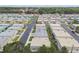 Aerial view showcases a neighborhood's layout with neatly arranged single-story homes and well-maintained streets and landscaping at 8447 Orleans N, Pinellas Park, FL 33781