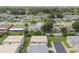Aerial view displays a quaint residential area with neat streets and a mix of lush trees at 8447 Orleans N, Pinellas Park, FL 33781