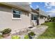 Home's backyard featuring well-kept lawn, patio with room for seating, and lush landscaping at 8447 Orleans N, Pinellas Park, FL 33781