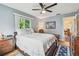 Bedroom with hardwood floors, ceiling fan, and natural light from the surrounding windows at 8447 Orleans N, Pinellas Park, FL 33781