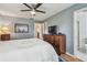 Comfortable bedroom with hardwood floors, ceiling fan, and closet with ensuite bath at 8447 Orleans N, Pinellas Park, FL 33781