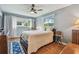Comfortable bedroom with hardwood floors, ceiling fan, and natural light from multiple windows at 8447 Orleans N, Pinellas Park, FL 33781