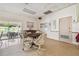 A bright clubhouse features a game table, piano, and relaxing seating at 8447 Orleans N, Pinellas Park, FL 33781