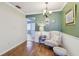 Cozy dining area with a comfortable chair and decorative wall art at 8447 Orleans N, Pinellas Park, FL 33781