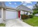 The exterior features a red front door, attached garage, and manicured landscaping at 8447 Orleans N, Pinellas Park, FL 33781