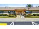 Exterior of the building entrance, showcasing a ramp, greenery, and a well-maintained facade at 8447 Orleans N, Pinellas Park, FL 33781