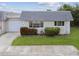 Charming home with a well-maintained lawn, fresh landscaping, and a gray roof at 8447 Orleans N, Pinellas Park, FL 33781