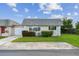 Charming single-story home with green lawn, flower beds, and large windows, offering cozy curb appeal at 8447 Orleans N, Pinellas Park, FL 33781