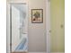 Hallway with blue rug leading to bathroom and adjacent yellow room at 8447 Orleans N, Pinellas Park, FL 33781