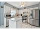 Well-maintained kitchen with stainless steel appliances, white cabinets, and subway tile backsplash at 8447 Orleans N, Pinellas Park, FL 33781