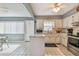 Classic kitchen features white cabinets, stainless steel appliances and an island for meal preparation at 8447 Orleans N, Pinellas Park, FL 33781