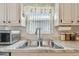 Classic kitchen sink with ample counter space and bright natural light from a nearby window at 8447 Orleans N, Pinellas Park, FL 33781
