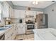 Charming kitchen with stainless steel appliances and white cabinets at 8447 Orleans N, Pinellas Park, FL 33781