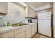 Kitchenette featuring essential appliances, double sink, and plentiful counter space at 8447 Orleans N, Pinellas Park, FL 33781