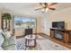 Comfortable living room with a ceiling fan, a neutral rug, and a large window at 8447 Orleans N, Pinellas Park, FL 33781