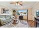 Comfortable living room with a ceiling fan, a neutral rug, and a large window at 8447 Orleans N, Pinellas Park, FL 33781