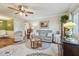 Cozy living room with ceiling fan, area rug, couch, and large window at 8447 Orleans N, Pinellas Park, FL 33781