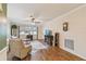 Bright living room with hardwood floors, ceiling fan and large window letting in natural light at 8447 Orleans N, Pinellas Park, FL 33781